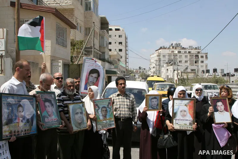 Palestinians hold pictures of relatives whose bodies remain in Israel during a protest in the West Bank city of Nablus on August 30, 2010. The families of Palestinians who were killed by the military during the First (19...
