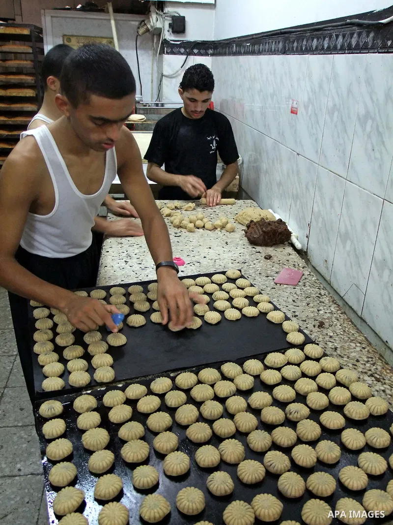 A Palestinian baker prepares mini-cakes at his bakery on September 6, 2010 Gaza city, as Muslims around the world prepare for the end of the holy month of Ramadan with the Eid al-Fitr holiday at the end of the week. Phot...