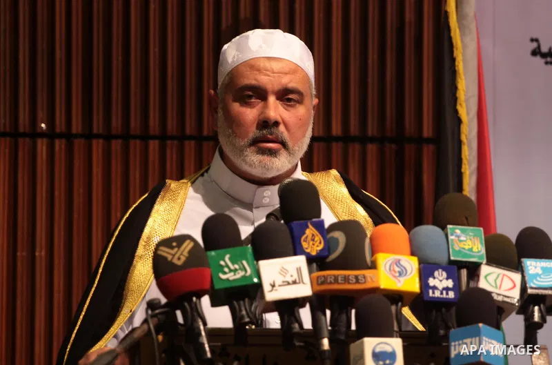 Palestinian Prime Minister in Gaza Strip, Ismail Haniyeh takes his breakfast during the Islamic holy month of Ramadan with Palestinian religious characters in Gaza city on Sept. 6,2010. Muslims abstain from drinking, eat...