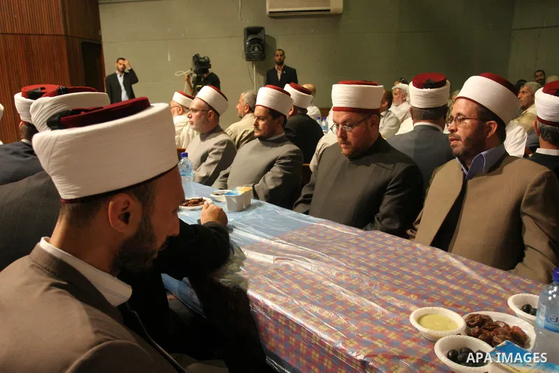 Palestinian Prime Minister in Gaza Strip, Ismail Haniyeh takes his breakfast during the Islamic holy month of Ramadan with Palestinian religious characters in Gaza city on Sept. 6,2010. Muslims abstain from drinking, eat...