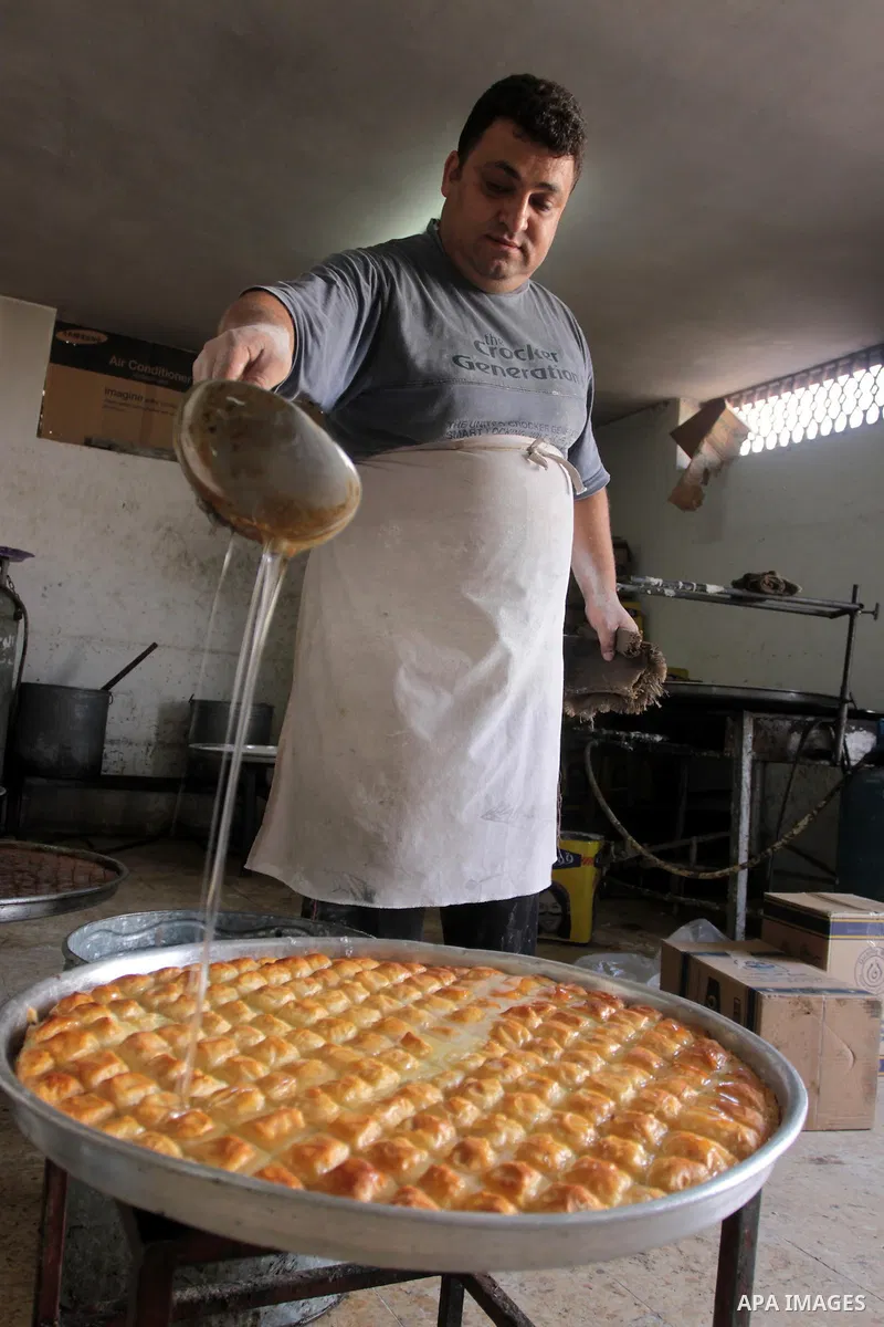 A Palestinian vendor prepares a traditional sweets at his shop in Gaza City on Sept 7,2010, as Muslims the world over prepare to celebrate Eid al-Fitr, a three day holiday marking the end of the religious month of Ramada...