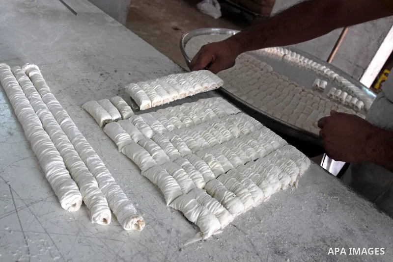 A Palestinian vendor prepares a traditional sweets at his shop in Gaza City on Sept 7,2010, as Muslims the world over prepare to celebrate Eid al-Fitr, a three day holiday marking the end of the religious month of Ramada...