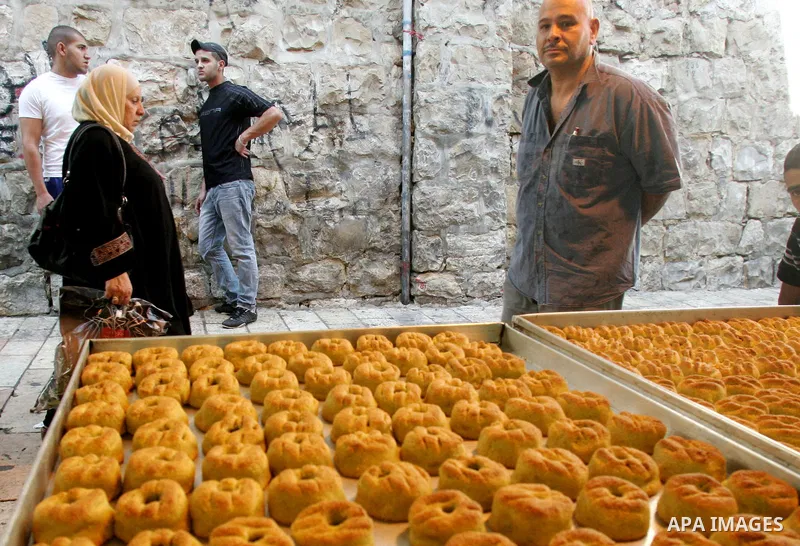 A Palestinian man sells date-filled mini cakes traditional for the Eid al-Fitr, a three-day holiday that marks the end of the fasting month of Ramadan, in Jerusalem's Old City on September 8, 2010. Photo by Mahfouz Abu T...