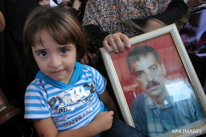 Palestinian women and children hold pictures of jailed relatives during a protest calling for the release of Palestinian prisoners from Israeli jails at the Red Cross office in Gaza City on Sept 13,2010 . Photo by Mohamm...