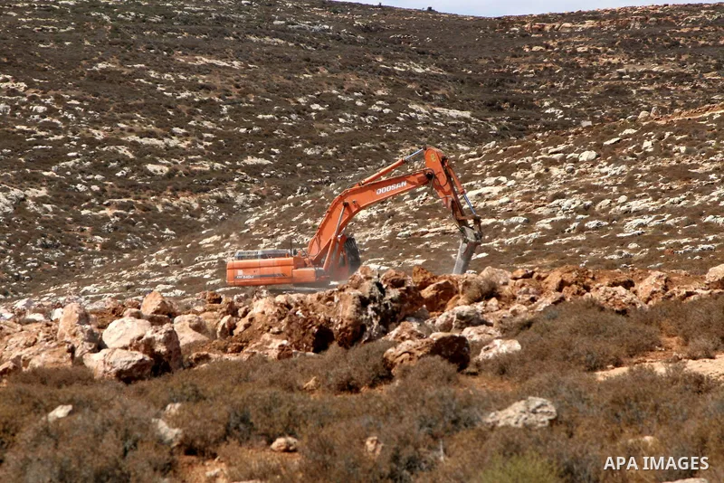 Israeli bulldozers and diggers for Jewish settlers work at a land to build a new settlement in the Palestinian village of Qarut, near the West Bank city of Nablus on Sept. 13, 2010 . Photo by Wagdi Eshtayah