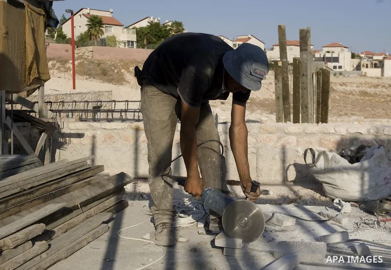 A Palestinian laborer works on a construction site in the West Bank Jewish settlement of Maala Adomeem, on the outskirts of Jerusalem on September 15, 2010. Photo by Mahfouz Abu Turk