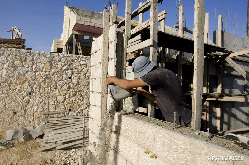 A Palestinian laborer works on a construction site in the West Bank Jewish settlement of Maala Adomeem, on the outskirts of Jerusalem on September 15, 2010. Photo by Mahfouz Abu Turk