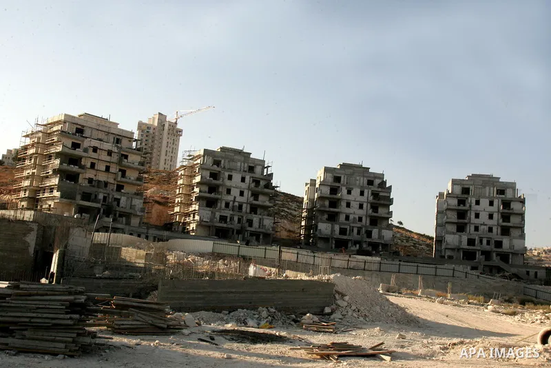 Palestinian laborers work on a construction site in the Jewish settlement of Har Homa, on the outskirts of Jerusalem on September 16, 2010. US Secretary of State Hillary Rodham Clinton arrived to the Palestinian Authorit...