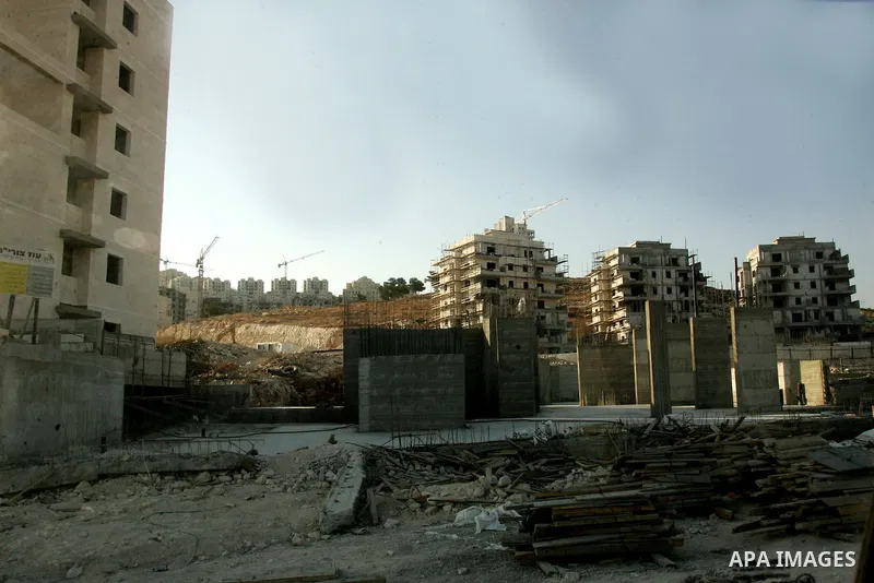 Palestinian laborers work on a construction site in the Jewish settlement of Har Homa, on the outskirts of Jerusalem on September 16, 2010. US Secretary of State Hillary Rodham Clinton arrived to the Palestinian Authorit...