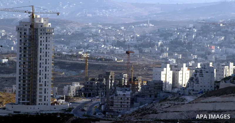 Palestinian laborers work on a construction site in the Jewish settlement of Har Homa, on the outskirts of Jerusalem on September 16, 2010. US Secretary of State Hillary Rodham Clinton arrived to the Palestinian Authorit...