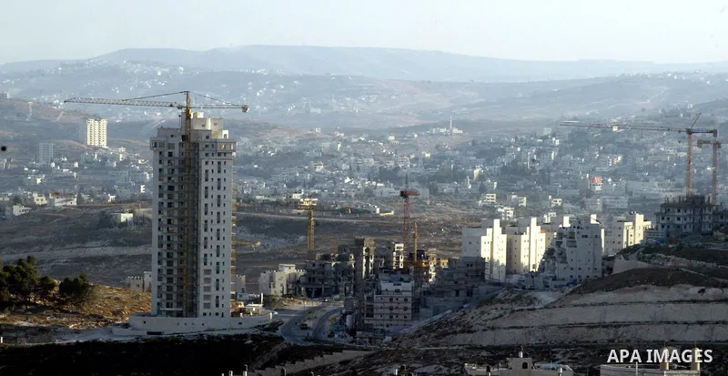 Palestinian laborers work on a construction site in the Jewish settlement of Har Homa, on the outskirts of Jerusalem on September 16, 2010. US Secretary of State Hillary Rodham Clinton arrived to the Palestinian Authorit...