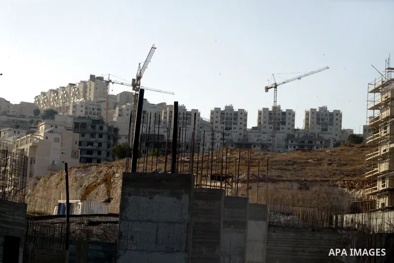 Palestinian laborers work on a construction site in the Jewish settlement of Har Homa, on the outskirts of Jerusalem on September 16, 2010. US Secretary of State Hillary Rodham Clinton arrived to the Palestinian Authorit...