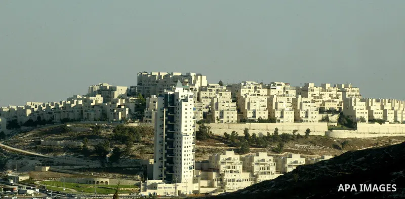 Palestinian laborers work on a construction site in the Jewish settlement of Har Homa, on the outskirts of Jerusalem on September 16, 2010. US Secretary of State Hillary Rodham Clinton arrived to the Palestinian Authorit...
