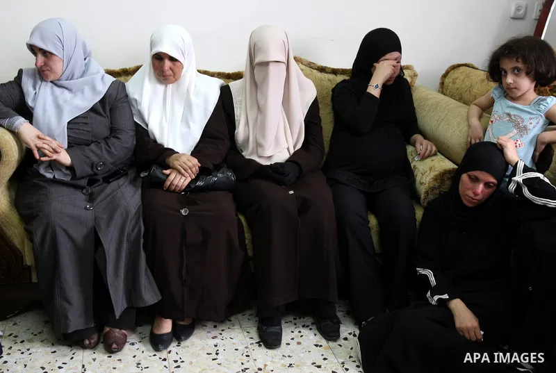 Family friends and relatives of Eyad Shilbaya, a 38-year-old local leader of the armed wing of the Islamist movement Hamas, mourn at his home after he was shot dead by Israeli soldiers on September 17, 2010 inside his be...