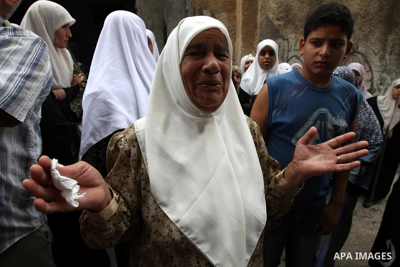 Family friends and relatives of Eyad Shilbaya, a 38-year-old local leader of the armed wing of the Islamist movement Hamas, mourn at his home after he was shot dead by Israeli soldiers on September 17, 2010 inside his be...