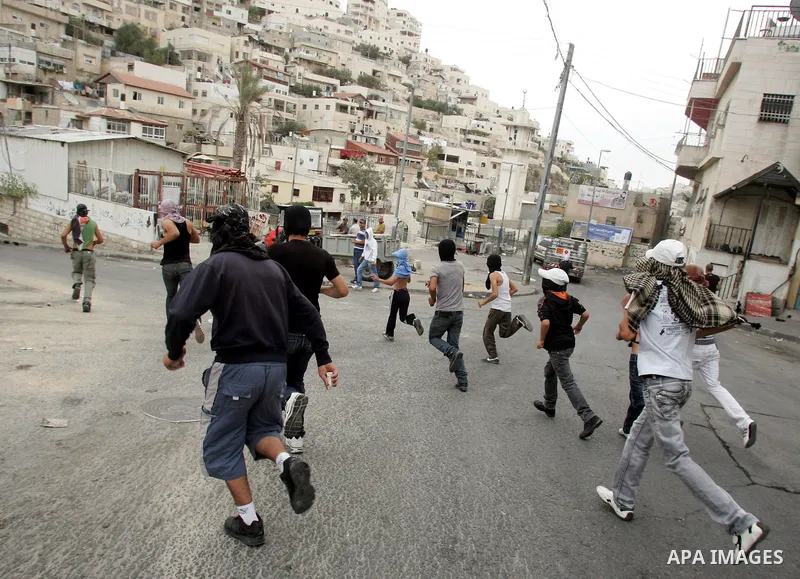 Palestinian youths hurl stones at Israeli soldiers during the clashes in the east Jerusalem neighborhood of Silwan, Wednesday, Sept. 22, 2010. Violence erupted after a 32-year-old Palestinian laborer was killed by a priv...