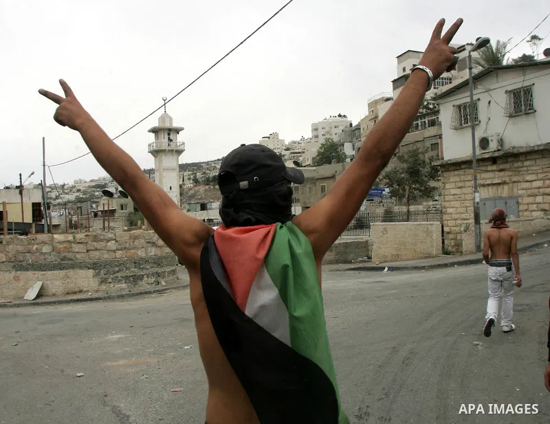 Palestinian youths hurl stones at Israeli soldiers during the clashes in the east Jerusalem neighborhood of Silwan, Wednesday, Sept. 22, 2010. Violence erupted after a 32-year-old Palestinian laborer was killed by a priv...