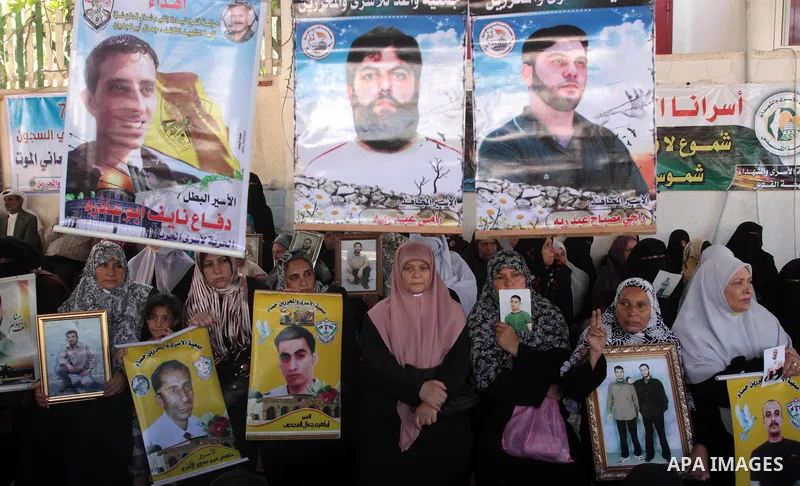 Palestinian women hold pictures of jailed relatives during a protest calling for the release of Palestinian prisoners from Israeli jails at the Red Cross office in Gaza City on Sept 27,2010 . Photo by Mohammed Asad