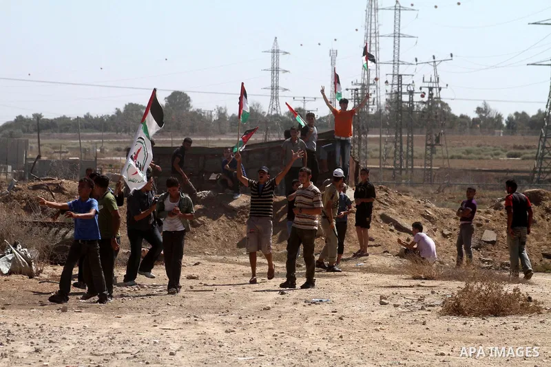 Palestinians hurl stones at Israeli troops (not pictured) during a demonstration to mark the 10th anniversary of the Al-Aqsa Intifada , in the east of Al Shejaeya area in the east of Gaza City, in Gaza Strip on Sept. 29,...