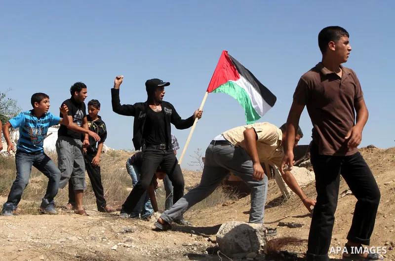 Palestinians hurl stones at Israeli troops (not pictured) during a demonstration to mark the 10th anniversary of the Al-Aqsa Intifada , in the east of Al Shejaeya area in the east of Gaza City, in Gaza Strip on Sept. 29,...