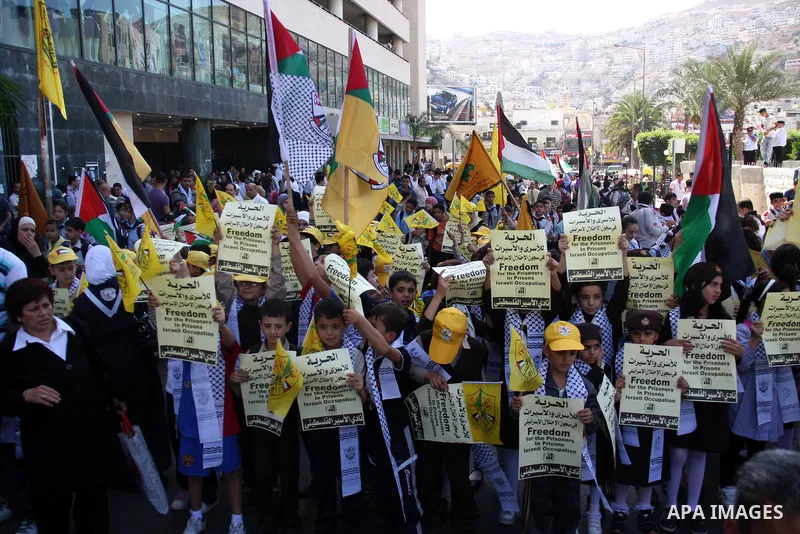 Palestinians children hold pictures of relatives, held in Israeli jails, during a protest calling for their release in the West Bank city of Nablus, Wednesday on Sept. 29, 2010 . Photo by Wagdi Eshtayah