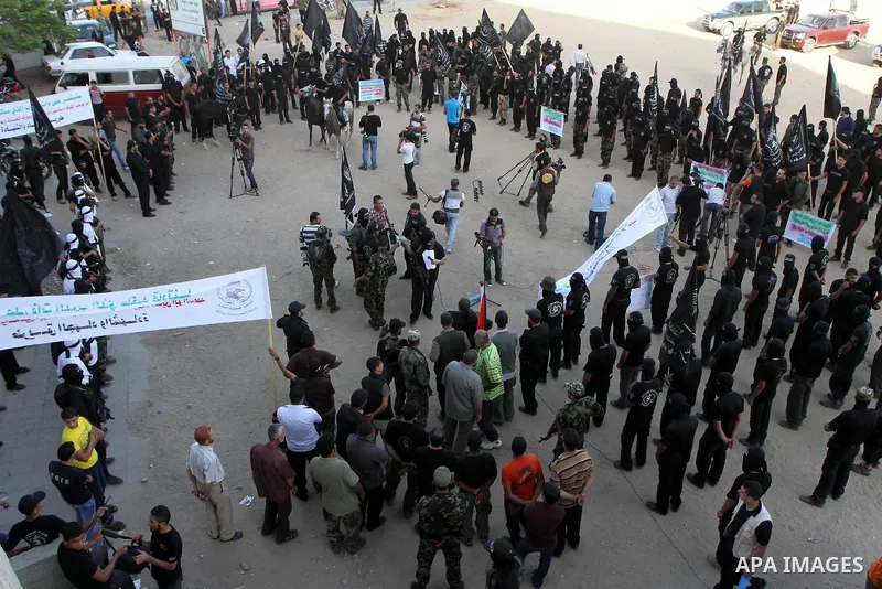 Palestinian militants of the Popular Resistance Committee hold their guns during a rally to mark the 10th anniversary of Al-Aqsa intifada (uprising) in Gaza City, Wednesday, Sept. 29, 2010. Washington's special Mideast e...