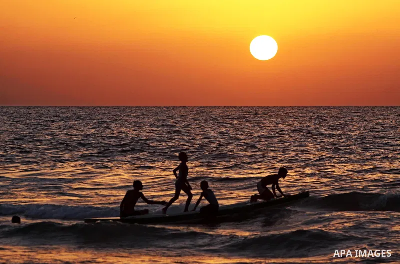 Palestinian children play at the beach during sunset in Gaza City beach on Sept. 29,2010 . Photo by Mohammed Asad