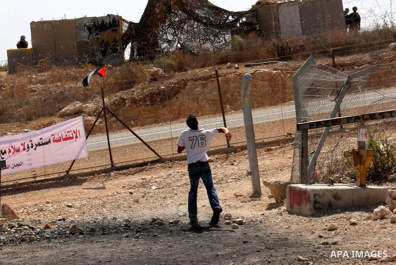 A Palestinian youth hurls stones at Israeli soldiers during a protest against Israel's separation barrier in the West Bank village of Bilin near Ramallah, Friday, Oct. 1, 2010. U.S. Middle East envoy George Mitchell was...