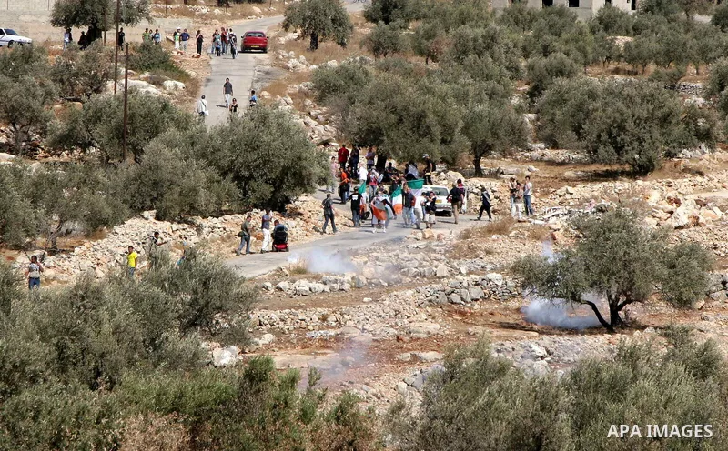 Palestinians and foreign activists take part in a protest against Israel's separation barrier in the West Bank village of Bilin near Ramallah, Friday, Oct. 1, 2010. U.S. Middle East envoy George Mitchell was shuttling be...