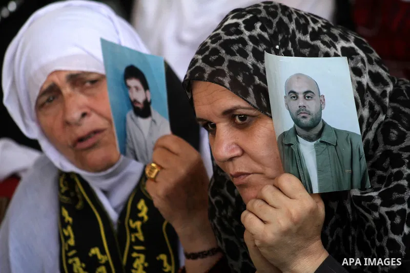 Palestinian women hold pictures of jailed relatives during a protest calling for the release of Palestinian prisoners from Israeli jails at the Red Cross office in Gaza City on October 4,2010 . Photo by Ashraf Amra
