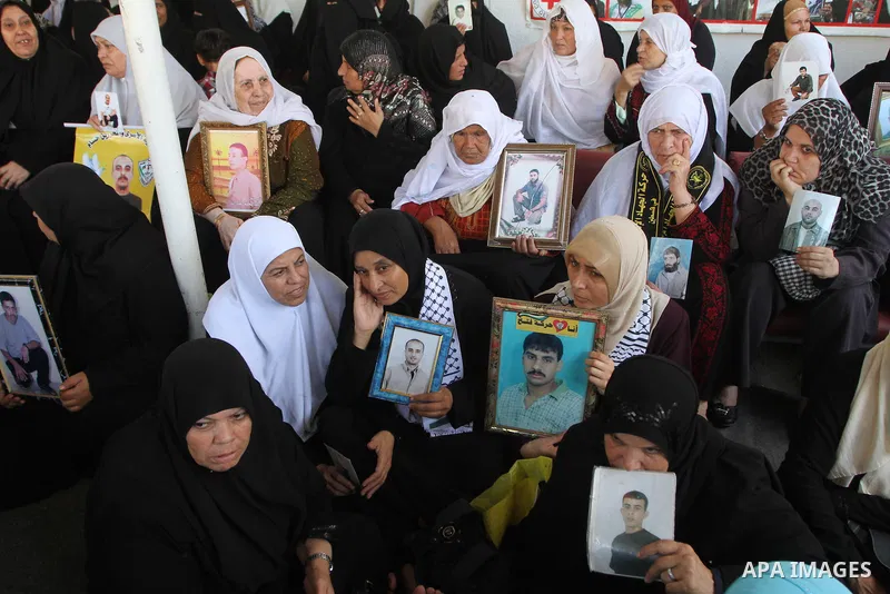Palestinian women hold pictures of jailed relatives during a protest calling for the release of Palestinian prisoners from Israeli jails at the Red Cross office in Gaza City on October 4,2010 . Photo by Ashraf Amra