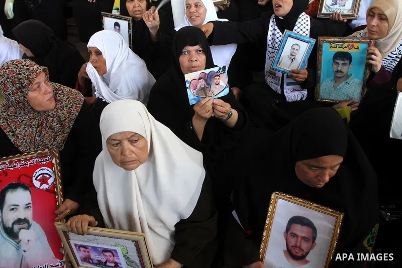 Palestinian women hold pictures of jailed relatives during a protest calling for the release of Palestinian prisoners from Israeli jails at the Red Cross office in Gaza City on October 4,2010 . Photo by Ashraf Amra