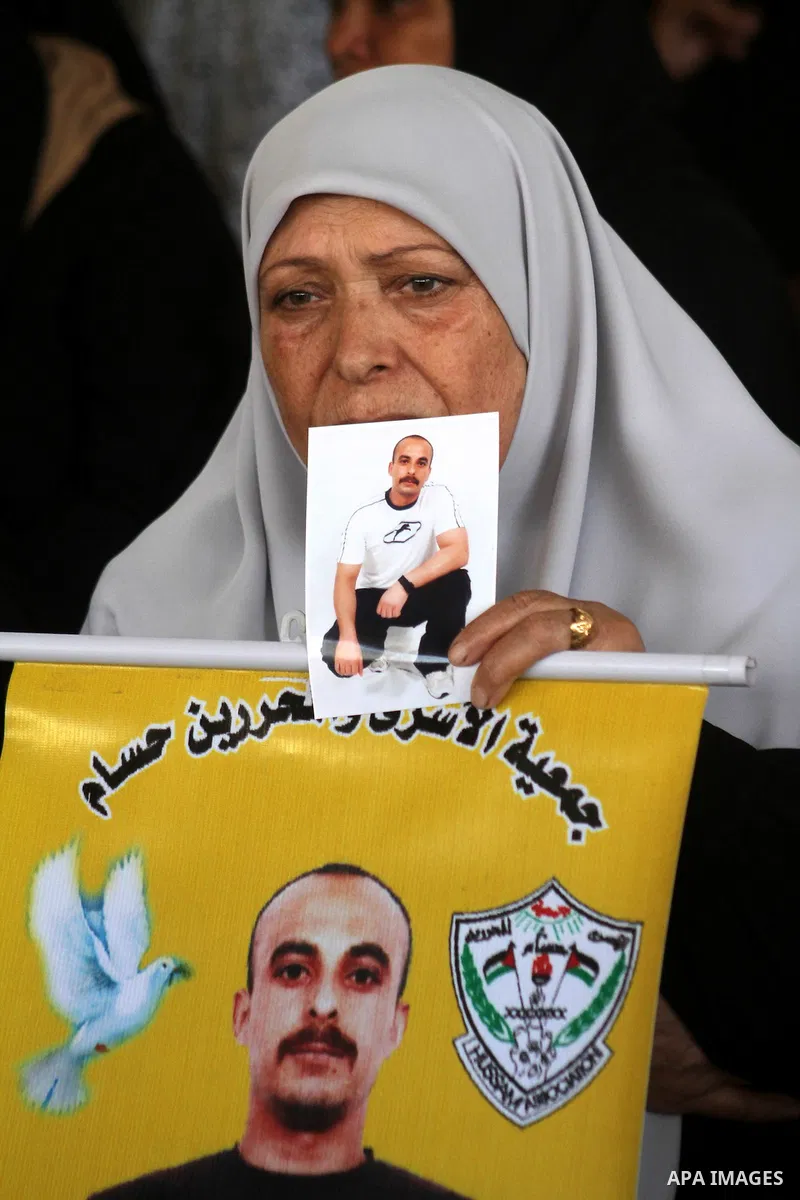Palestinian women hold pictures of jailed relatives during a protest calling for the release of Palestinian prisoners from Israeli jails at the Red Cross office in Gaza City on October 4,2010 . Photo by Ashraf Amra