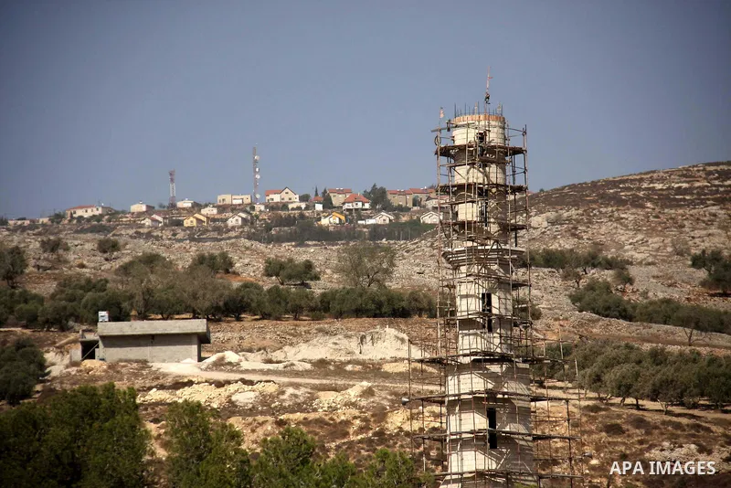 Over looked by the Har Bracha Jewish settlement, a mineret is under consruction in the Palestinian village of Burin in the Israeli occupied West Bank, several kilometers from the northern city of Nablus on October 4, 201...