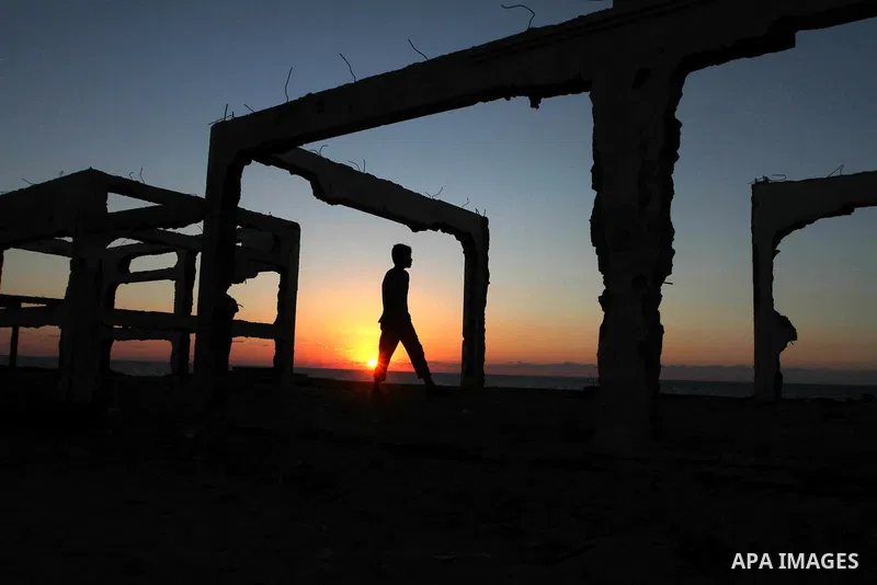 Palestinians work to re-manufacture cement from the remains of ruins of Palestinian buildings that were destroyed during the Israeli war against Hamas in the Gaza Strip, in the west of Beit Lahiya town in the northern Ga...