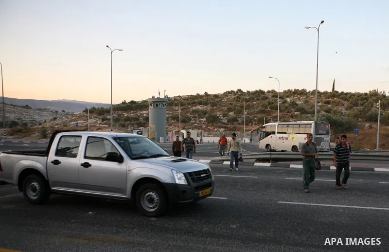 Palestinian workers walk to cross the Isreali controlled Modiin ( Bet seira ) checkpoint, between the West Bank and the Jewish settlement of Modiin Illit and all of Israeil , as they head to work in Israel and nearby set...