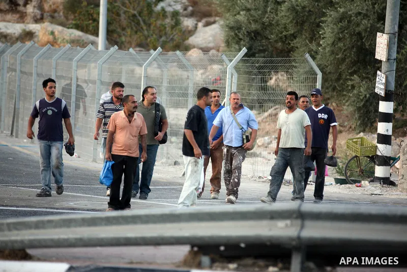 Palestinian workers walk to cross the Isreali controlled Modiin ( Bet seira ) checkpoint, between the West Bank and the Jewish settlement of Modiin Illit and all of Israeil , as they head to work in Israel and nearby set...