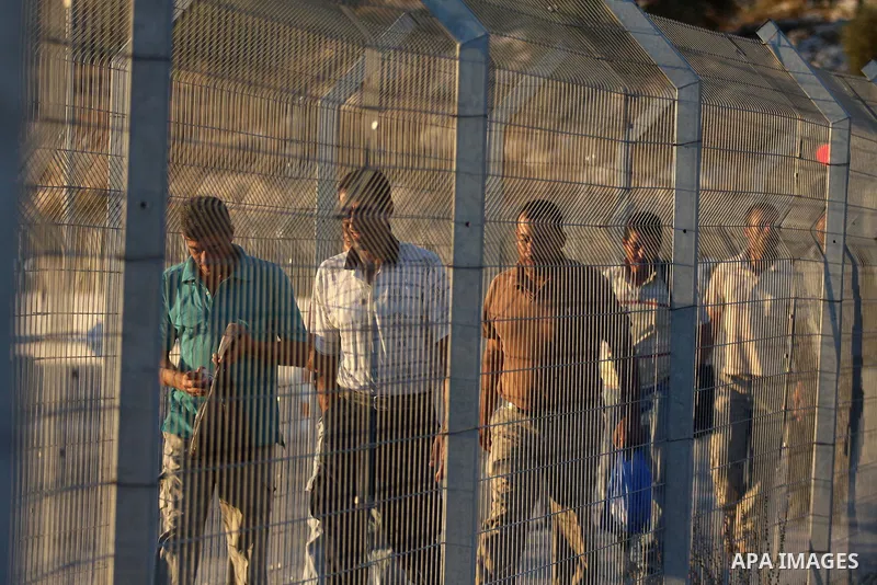 Palestinian workers walk to cross the Isreali controlled Modiin ( Bet seira ) checkpoint, between the West Bank and the Jewish settlement of Modiin Illit and all of Israeil , as they head to work in Israel and nearby set...