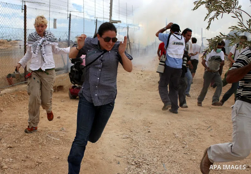 Israeli soldiers fire tear gas canisters during the clashes following a weekly demonstration against Israel's separation barrier in the West Bank village of Bilin, near Ramallah, on Oct. 8, 2010. Photo by Eyad Jadallah