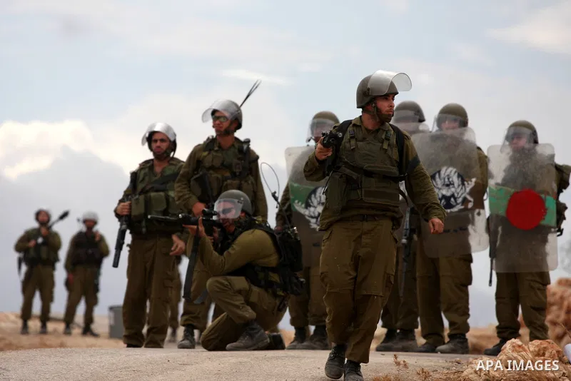 Israeli soldiers fire tear gas canisters during the clashes following a weekly demonstration against Israel's separation barrier in the West Bank village of Bilin, near Ramallah, on Oct. 8, 2010. Photo by Eyad Jadallah