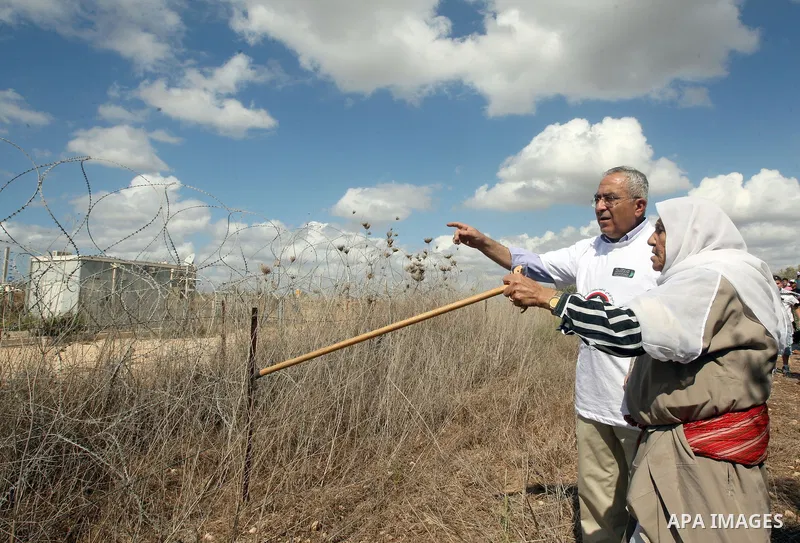 Palestinian Prime Minister Salam Fayyad as he gathering olives with villagers on the first day of the olive harvest in the West Bank village of Dair al-Ghsoun, near Tulkarem on October 9, 2010. For Palestinians, olives a...