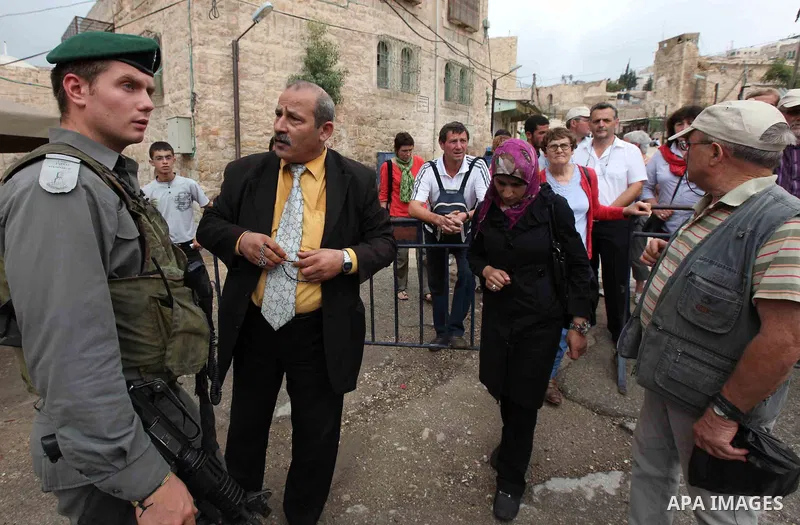 Israeli border police prevent the Palestinian and International visitors to cross at an Israeli-controlled checkpoint in the center of the Palestinian West Bank city of Hebron on October 09,2010 as they in their way to t...