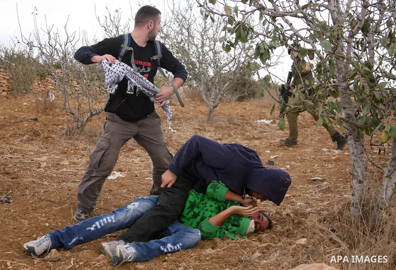 Israeli undercover forces arrest Palestinian boys during a demonstration by Palestinian, Israeli and foreign activists against the demolishing of farm land to be used in the construction of Jewish settlements near the ex...