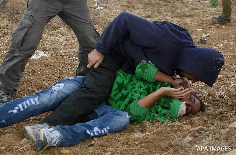 Israeli undercover forces arrest Palestinian boys during a demonstration by Palestinian, Israeli and foreign activists against the demolishing of farm land to be used in the construction of Jewish settlements near the ex...