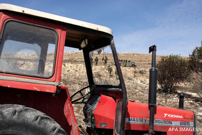 Israeli soldiers are seen at Palestinian agricultural fields during olive harvest in the West Bank village of Hawara, near Nablus on Oct. 10, 2010. Jewish settlers attacked Palestinian farmers during pick olives in their...
