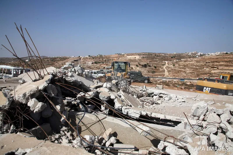 Israeli army bulldozer destroying a Palestinian house and water wells that belong to Rugby family , just east of the West Bank town of Hebron on October 11,2010 . Direct peace talks between the Palestinians and Israel ha...