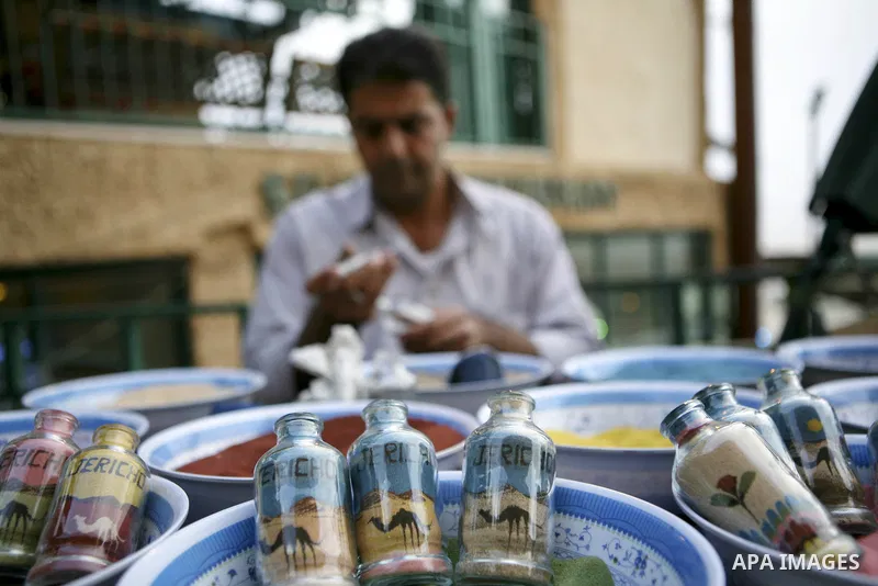 A Palestinian artist paints his paintings using colored sand in glass tubes,near West Bank city of Jericho , on Oct. 11.2010 . Jericho is one of the oldest continuously inhabited cities in the world, with evidence of set...