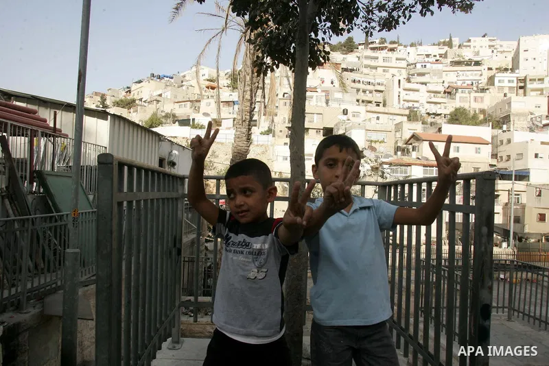 Palestinian children wave their hands with victory sign in the Arab east Jerusalem neighborhood of Silwan on Oct 14,2010. Palestinian children suffer from alot of attacks from Jewish settlers and Israeli soldiers as a Pa...