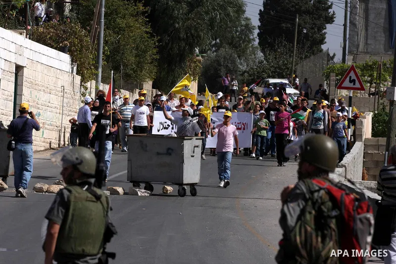Palestinians and foreign activists take part in a demonstration against the expansion of the nearby Jewish settlement of Halamish in the West Bank village of Nabi Saleh, Friday, Oct 15, 2010. Photo by Issam Rimawi