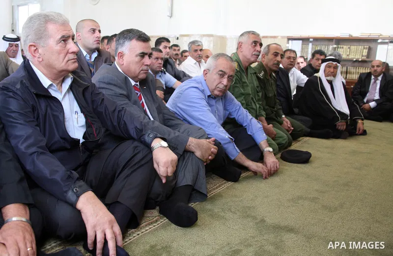 Palestinian prime minister Salam Fayyad attends Friday prayer among Palestinian officials at a West Bank mosque that was desecrated and burnt by jewish settlers in the village of Beit Fajjar, south of Bethlehem, on Octob...